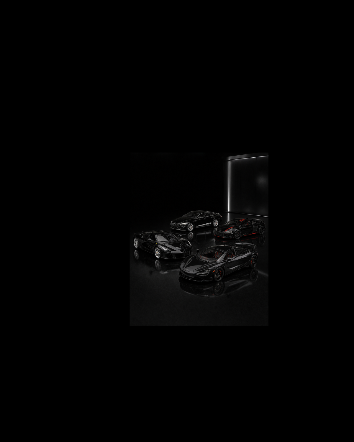 Four black McLaren, Ferrari, AMG and Audi-form performance collectibles inside a piano-black miniature night vault.