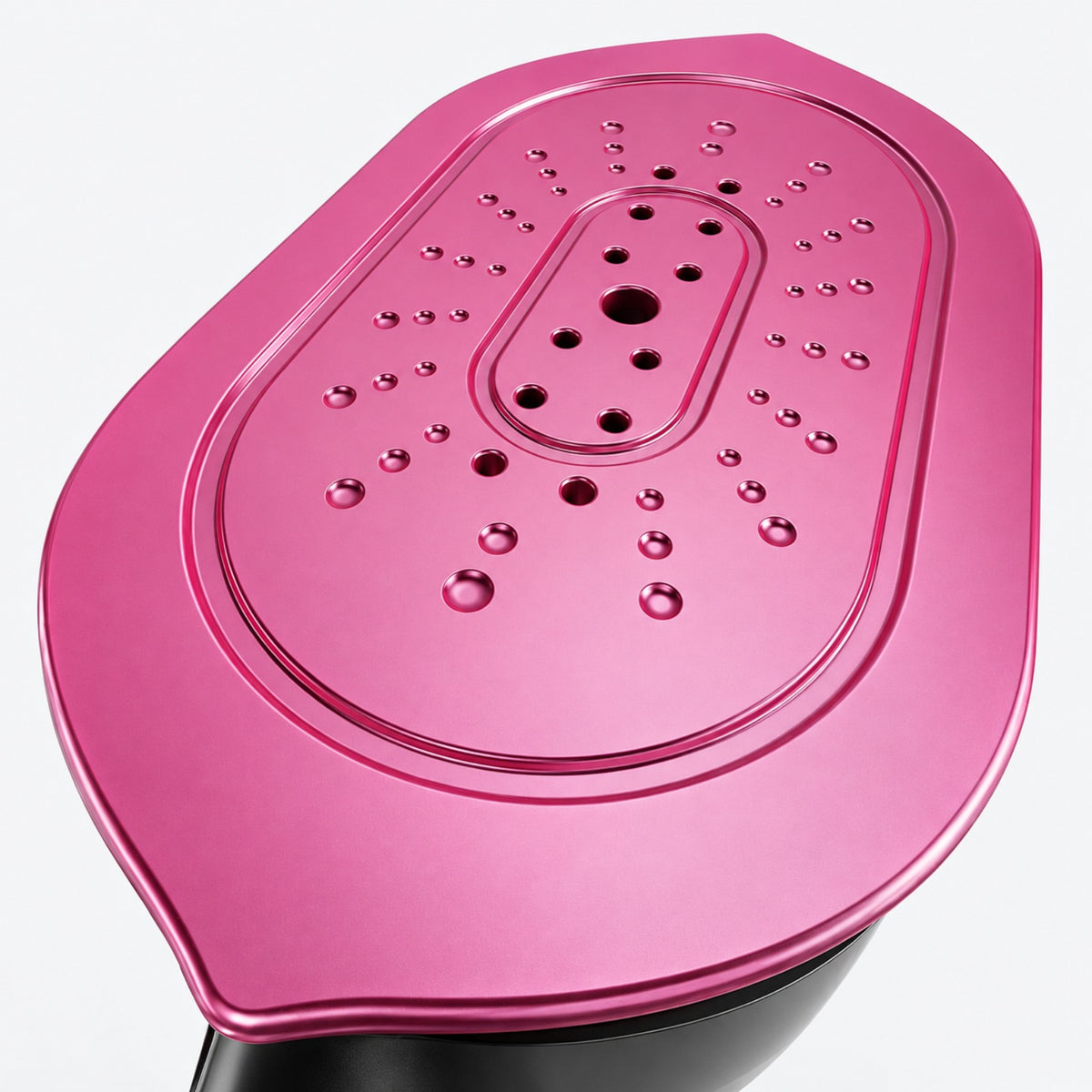 Close view of the supplier-style elongated magenta soleplate and steam openings