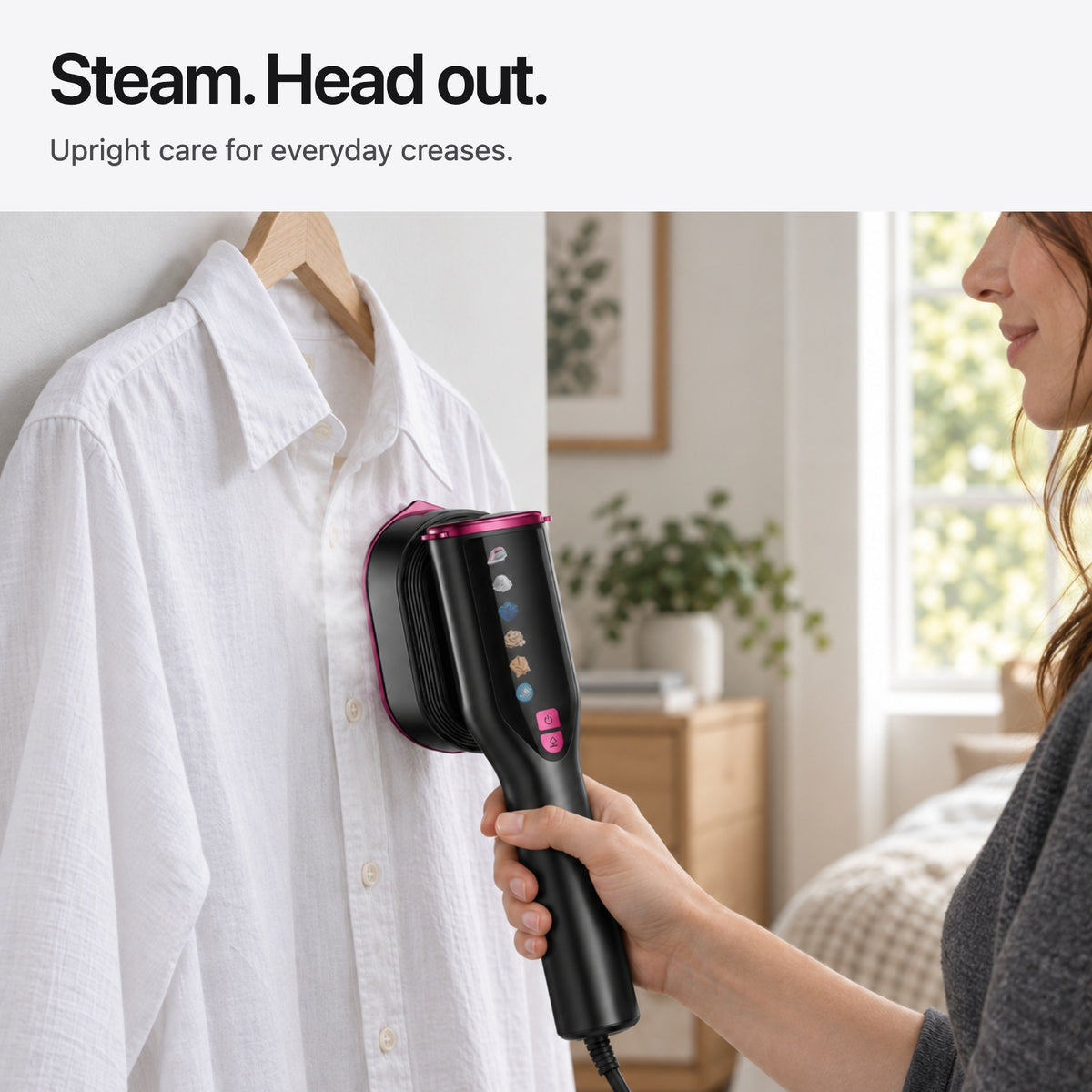 Carter & Cole handheld garment steamer used upright on a hanging cotton shirt